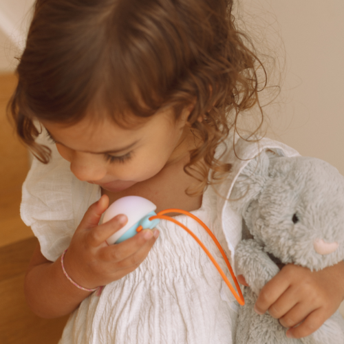 Girl holding the button on Snuggo to talk
